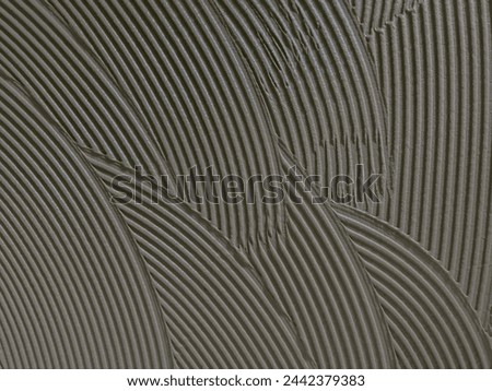 Texture cementitious adhesive applied to the floor ready to receive the ceramic tile
 Royalty-Free Stock Photo #2442379383