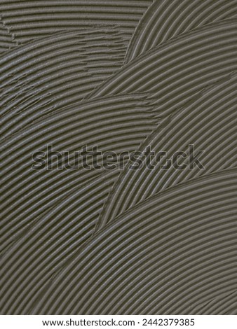 Texture cementitious adhesive applied to the floor ready to receive the ceramic tile
 Royalty-Free Stock Photo #2442379385