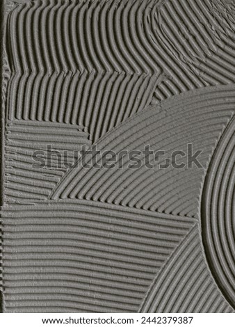Texture cementitious adhesive applied to the floor ready to receive the ceramic tile
 Royalty-Free Stock Photo #2442379387