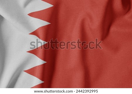 National Flag on Textured Fabric Background. Silk textured flag, realistic wave and flag look. BH  Flag of Bahrain