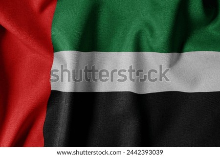 National Flag on Textured Fabric Background. Silk textured flag, realistic wave and flag look. AE  Flag of The United Arab Emirates