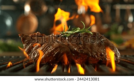 Tasty Beef Steak Placed on Grill Grid. Kitchen with utensils on Background. Concept of Food Preparation.