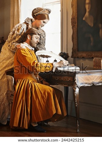 Couple, feather and writing a letter, royal and relax in home for history in noble palace. People, quill and bonding or notes in journal for plan, renaissance and aesthetic for support in marriage Royalty-Free Stock Photo #2442425215