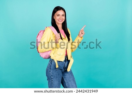 Profile side photo of young lovely girl indicate finger empty space ad choice backpack isolated over turquoise color background