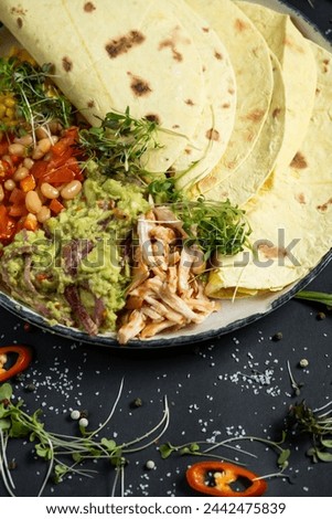 Mexican tacos on pita with vegetables salad, meat, pepper and corn on rustic wooden white table background. Recipe traditional food. Top flat view, overhead.