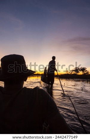 Mokoro Poler in Okavango Delta
 Royalty-Free Stock Photo #2442477149