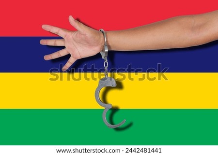 handcuffs with hand on Mauritius flag