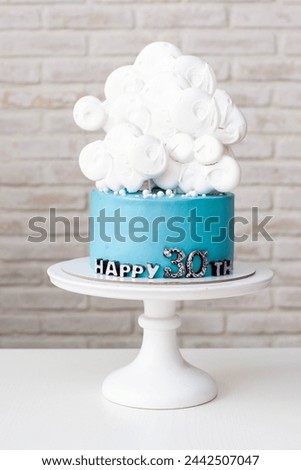 Blue birthday cake with white clouds for 30th anniversary on neutral background