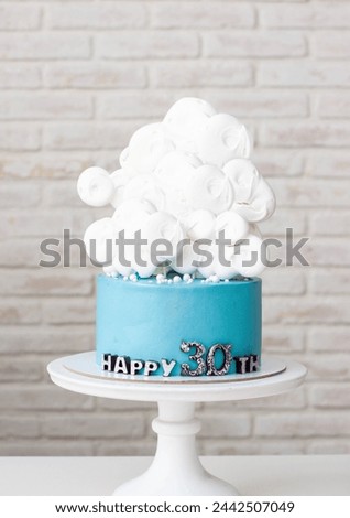 Blue birthday cake with white clouds for 30th anniversary on neutral background