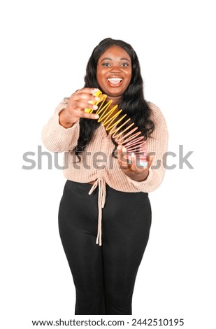 Cute young african female teacher holding a kids toy against a white background