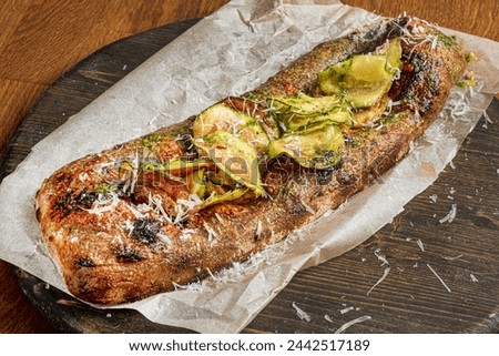 Genoese pizza on the wooden board Royalty-Free Stock Photo #2442517189