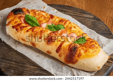 Genoese pizza on the wooden board Royalty-Free Stock Photo #2442517197