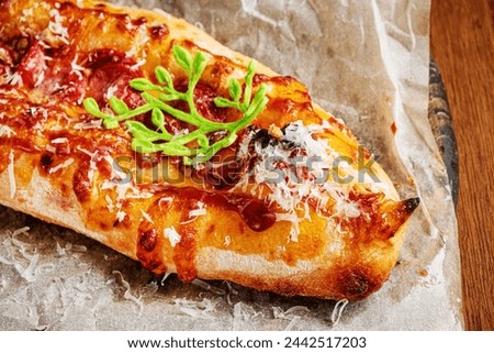 Genoese pizza on the wooden board Royalty-Free Stock Photo #2442517203