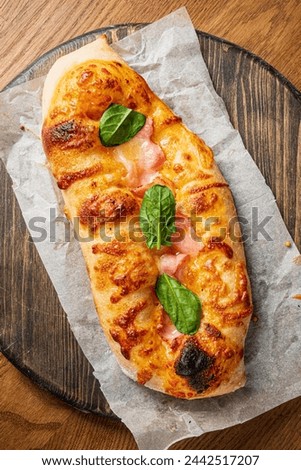 Genoese pizza on the wooden board Royalty-Free Stock Photo #2442517207