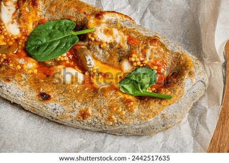 Genoese pizza on the wooden board Royalty-Free Stock Photo #2442517635