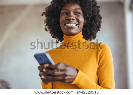 Mixed race businesswoman in coworking space. Phone, networking or black woman with smile for social media, thinking of blog marketing idea or mobile app software. 