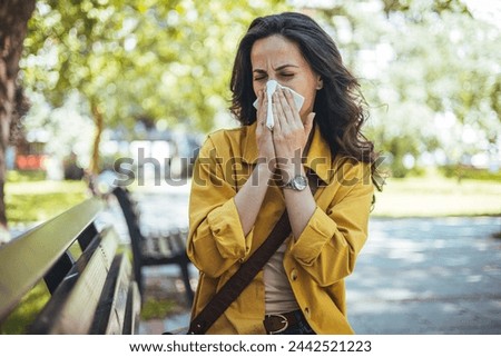 Woman has sneezing. Young woman is having flu and she is sneezing. Sickness, seasonal virus problem concept. Woman being sick having flu sneezing.