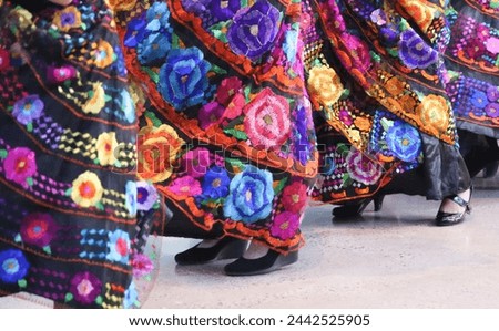 Cinco de Mayo Mexican Dancers Swinging Bright Colorful Dresses Royalty-Free Stock Photo #2442525905