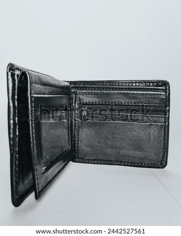 Showcasing craftsmanship, this photo captures the timeless elegance of a handmade men's wallet, crafted from premium black leather. The detailed image of the wallet.