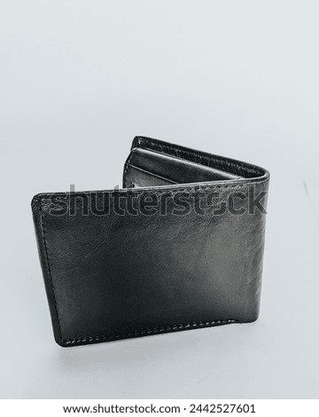 Showcasing craftsmanship, this photo captures the timeless elegance of a handmade men's wallet, crafted from premium black leather. The detailed image of the wallet.