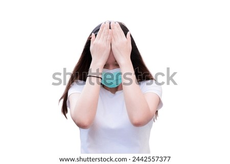 Stressed woman holding her head in pain, feeling upset, Person wearing green medical face mask, On isolated background.