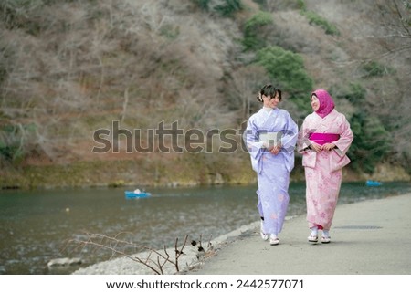 Travel, muslim travel, Arashiyama, woman girl tourist Two Asian friends but different religions in traditional japanese kimonos walking and travel   to Tenryu-ji temple, Kyoto, Arashiyama, Japan.