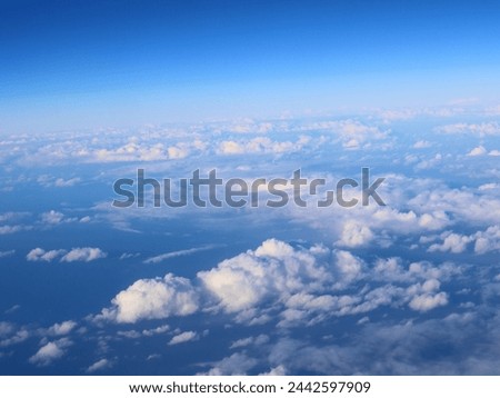 Various pictures of clouds taken from an aircraft. Some were taken in the day and some in the evening. Some will include the aircraft wing and some will include the curved horizon.