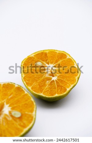 Orange peel texture with seed. Half-orange fruit placed on a white background. Image of Thai tangerine with the concept of fruit with an orange color and healthy eating. Close-up food and seed texture
