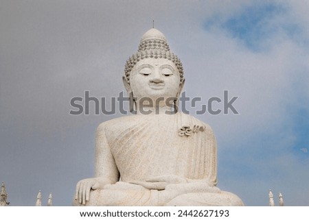 Fine art travel photography of Big Buddha sitting high upon a hill looking down upon people below in Phuket, Thailand. 
