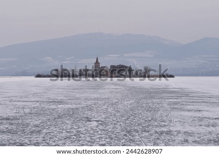 Beautiful old church of St. Linhart. Catholic temple village of Musov - Pasohlavky, Czech Republic. Photo of winter landscape with sunset on a dam New Mills (Nove Mlyny).