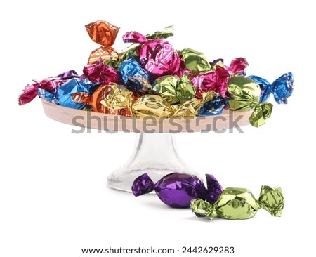 Stand with candies in colorful wrappers isolated on white Royalty-Free Stock Photo #2442629283