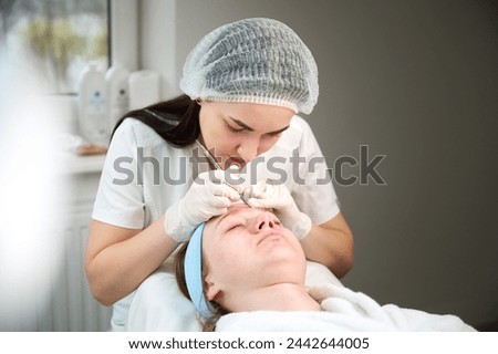Close up of ultrasound skin cleaning and facial peeling procedure in beauty clinic. Macro shot of woman under procedure of ultrasonic facial. Deep pore cleansing treatment