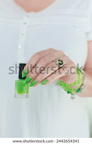 Female hand with long nails and neon green manicure