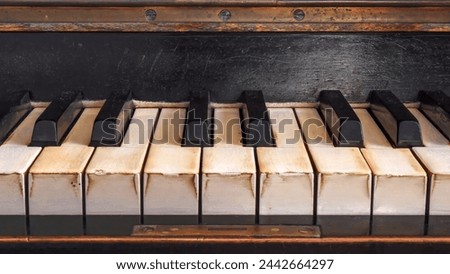 an old piano keyboard with many signs of use
