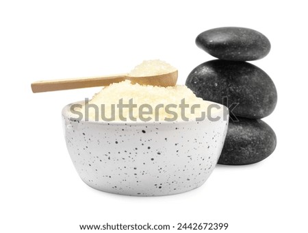 Sea salt in bowl, spoon and spa stones isolated on white