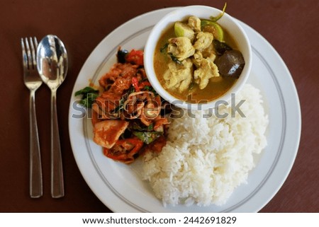 
In this picture we see a beautiful and delicious Thai food menu. which includes "Stir-fried seafood" and "Chicken green curry"