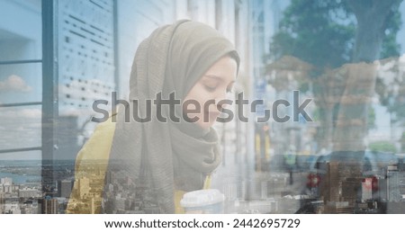 Image of asian woman in hijab drinking coffee over landscape. out and about in the city, digitally generated image.