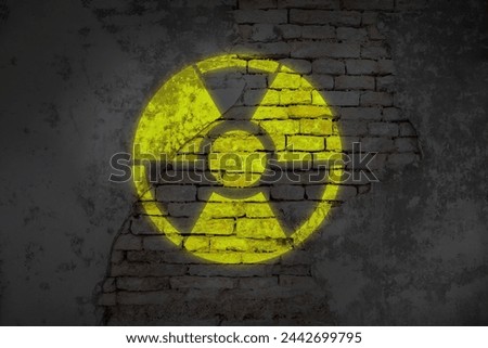 Radioactive sign on old brick wall. Hazard symbol