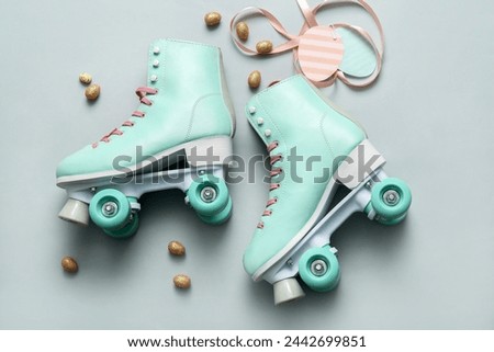 Vintage roller skates and Easter eggs on grey background