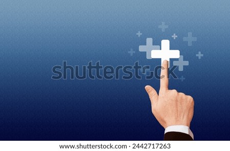 Hand touching the first aid sign, healthcare and hospital concept.