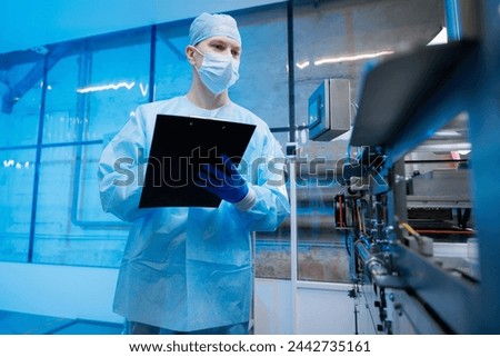Worker use clipboard for control quality on automatic machine production line for manufacture of medical plastic form for surgical kit Royalty-Free Stock Photo #2442735161