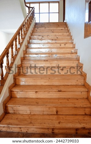 Wooden stair case in a building. wooden railing. beautiful architecture, photography. India. polished reflective surface. well maintained.