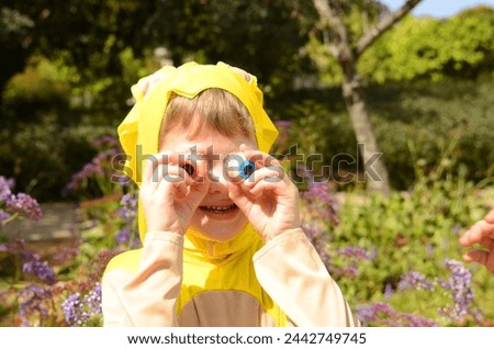 Schoolboy boy in carnival costume, Halloween, Purim. Child holding creepy monster eyes candy