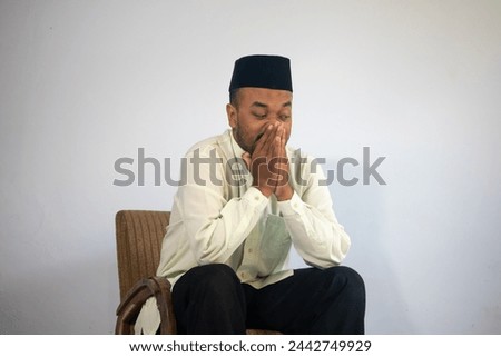 sleepy muslim man sitting on a chair