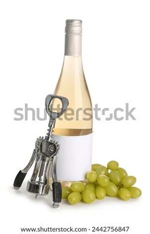Bottle of exquisite wine, corkscrew and grapes on white background