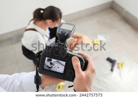 FBI agent with photo camera at crime scene, closeup