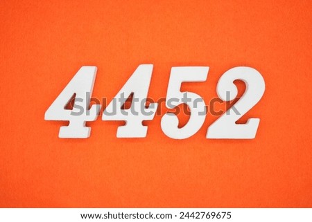 Orange felt is the background. The numbers 4452 are made from white painted wood.