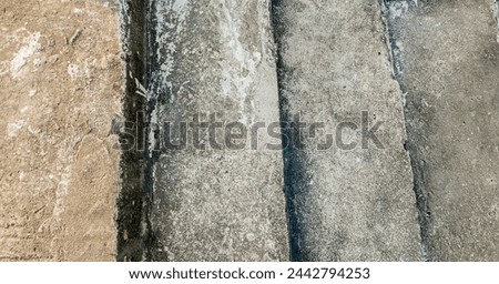 High resolution, textured background of old, cracked concrete slabs with space for text, ideal for construction and urban decay themes