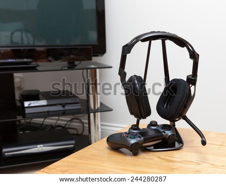 gaming headphones and controller Royalty-Free Stock Photo #244280287