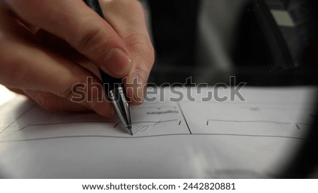 A businessman in close-up working at a desk in an office with documentation